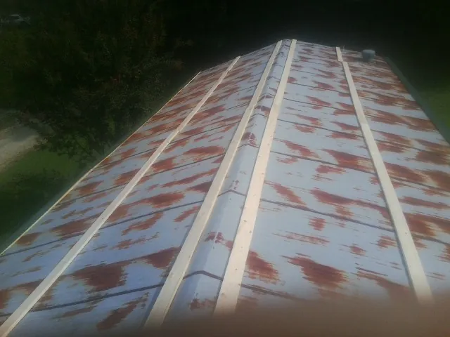 Rusted metal roof panels with new wood purlins before replacement — Storm Damage Roof Repair in Mountain Rest by Roofing Brothers