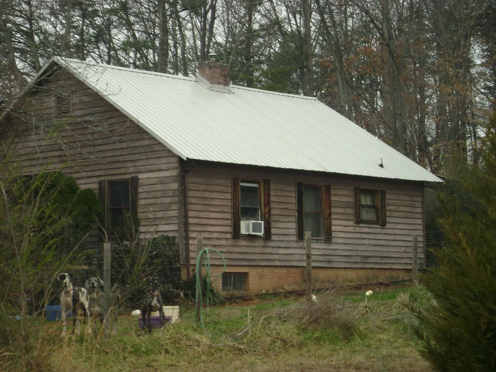 White metal roof on an old wood sided farmhouse, from a Asphalt Shingle Roof Repair job in Mountain Rest