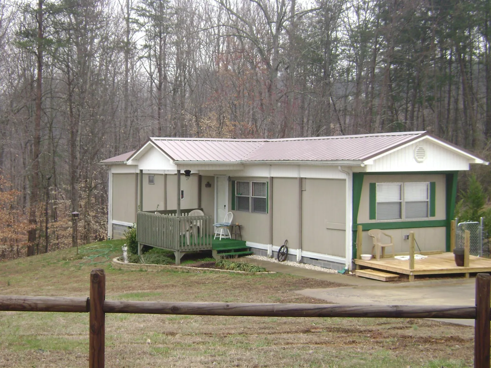 Mauve metal roof on a manufactured home with a new front deck in Mountain Rest